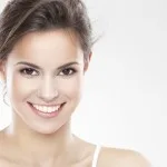 Beauty portrait of a young brunette woman with beautiful smile